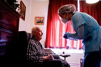 TOPSHOT - A nurse arrives to test a resident of the elderly residence Christalain on April 17, 2020 in Brussels, during a strict lockdown in the country to fight against the novel coronavirus. (Photo by kenzo tribouillard / AFP)