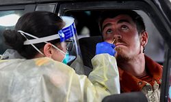 A member of the Australian Defence Force (L) takes a swab for a COVID-19 coronavirus test on a member of the public in Melbourne on June 27, 2020. - Officials reported another 41 new COVID-19 infections in the city overnight in a continuing outbreak that has raised fears of a second wave in Australia, which looked like it had successfully contained the epidemic. (Photo by William WEST / AFP)