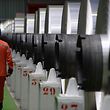 (FILES) In this file photo taken on December 12, 2014 an employee walks along aluminum rolls at a factory in Biesheim, eastern France.  Imposed stiff tariffs by the United States on European, Mexican and Canadian steel and aluminium, that have come into effect on June 1, 2018, have sparked immediate countermeasures by Mexico and Canada, while the European Union threatened a similar response, throwing up the prospect of a painful conflict between some of the world's biggest economies.  / AFP PHOTO / Patrick HERTZOG