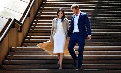 (FILES) In this file photo taken on October 16, 2018 Britain's Prince Harry and his wife Meghan walk down the stairs of the iconic Opera House in Sydney to meet people. - Prince Harry Meghan Markle announced on June 6, 2021 the birth of their daughter Lilibet Diana, who was born in California after a year of turmoil in Britain's royal family. "Lili is named after her great-grandmother, Her Majesty The Queen, whose family nickname is Lilibet. Her middle name, Diana, was chosen to honor her beloved late grandmother, The Princess of Wales," said a statement from the couple. (Photo by STR / AFP)