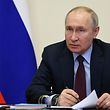 Russian President Vladimir Putin presides over a meeting with members of the government via videoconference at his official residence in Novo-Ogaryovo province outside Moscow, January 11, 2023.