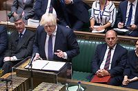 A video grab from footage broadcast by the UK Parliament's Parliamentary Recording Unit (PRU) shows Britain's Prime Minister Boris Johnson speaking at the despatch box during an extraordinary session of parliament called to discuss the collapse of the Afghan government in the House of Commons in London on August 18, 2021. - Britain on August 17 announced a resettlement scheme for Afghans fleeing the Taliban after their return to power, offering an initial 5,000 places in the first year, rising to up to 20,000 in the long term. The announcement came on the eve of an extraordinary session of parliament on August 18, where MPs recalled from holiday will discuss the collapse of the Afghan government, so soon after the withdrawal of Western forces. (Photo by - / PRU / AFP) / RESTRICTED TO EDITORIAL USE - MANDATORY CREDIT " AFP PHOTO / PRU " - NO USE FOR ENTERTAINMENT, SATIRICAL, MARKETING OR ADVERTISING CAMPAIGNS