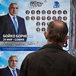A man looks at election posters of Bulgarian Prime Minister and leader of centre-right GERB party Boyko Borissov in Bankya on April 2, 2021, ahead of the General elections in two days. - Bulgarians will go to the polls on April 4, to elect a new parliament, with Prime Minister Boyko Borisov's centre-right party tipped to finish first despite a wave of anti-government protests last summer. While the latest polls give Borisov's GERB party an average lead of eight percentage points over the main opposition Socialists, analysts still expect the next parliament to be marked by more instability. (Photo by Nikolay DOYCHINOV / AFP)