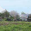 Taiwan military soldiers fire the 155-inch howitzers during a live fire anti landing drill in the Pingtung county, southern Taiwan on August 9, 2022. (Photo by Sam Yeh / AFP)