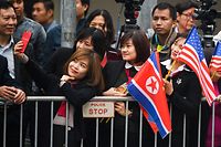 A woman takes a selfie as people gather around a street in Hanoi on February 26, 2019, ahead the second US-North Korea summit. - North Korean leader Kim Jong Un crossed into Vietnam on February 26 after a marathon train journey for a second summit showdown with Donald Trump, with the world looking for concrete progress over the North's nuclear programme. (Photo by Noel CELIS / AFP)