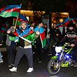 Azerbaijanis celebrate in the streets of Baku on November 10, 2020. - Armenia and Azerbaijan agreed on a deal with Russia to end weeks of fierce clashes over Nagorno-Karabakh on Tuesday, after a string of Azerbaijani victories in its fight to retake the disputed region. Azerbaijani President Ilham Aliyev said Tuesday that a ceasefire deal to end fighting over the disputed Nagorno-Karabakh region amounted to a "capitulation" by foe Armenia. (Photo by Tofik BABAYEV / AFP)