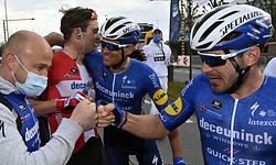 Danish Kasper Asgreen (2L) celebrates with teammates of Deceuninck - Quick-Step after winning the 'E3 Saxo Bank Classic' cycling race, 203,9km from and to Harelbeke, on March 26, 2021. (Photo by DIRK WAEM / Belga / AFP) / Belgium OUT