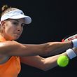 Mandy Minella of Luxembourg hits a return against Magda Linette of Poland during their women's singles match on day two of the Australian Open tennis tournament in Melbourne on January 17, 2017. / AFP PHOTO / SAEED KHAN / IMAGE RESTRICTED TO EDITORIAL USE - STRICTLY NO COMMERCIAL USE