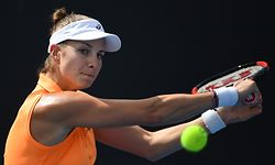 Mandy Minella of Luxembourg hits a return against Magda Linette of Poland during their women's singles match on day two of the Australian Open tennis tournament in Melbourne on January 17, 2017. / AFP PHOTO / SAEED KHAN / IMAGE RESTRICTED TO EDITORIAL USE - STRICTLY NO COMMERCIAL USE
