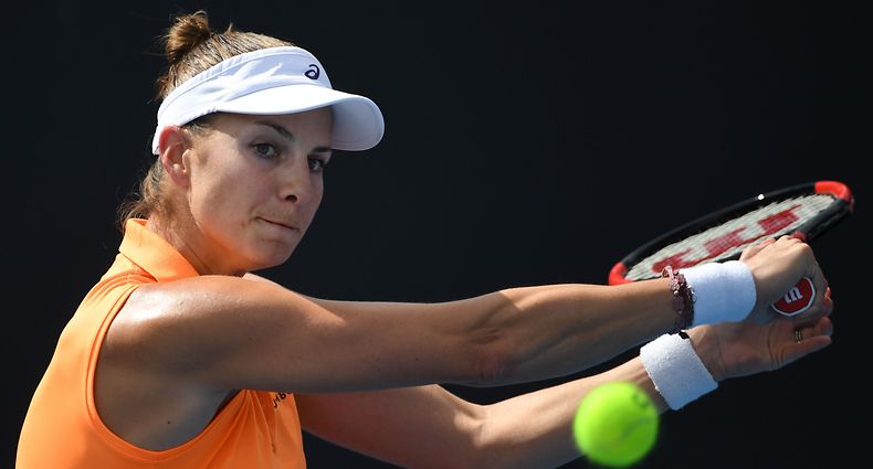 Mandy Minella of Luxembourg hits a return against Magda Linette of Poland during their women's singles match on day two of the Australian Open tennis tournament in Melbourne on January 17, 2017. / AFP PHOTO / SAEED KHAN / IMAGE RESTRICTED TO EDITORIAL USE - STRICTLY NO COMMERCIAL USE