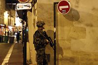 (FILES) In this file photograph taken early November 14, 2015, a French soldier secures the area near La Belle Equipe, Rue de Charonne in Paris, after a series of attacks occurred across Paris as well as explosions outside the national stadium where France was hosting Germany in a friendly football match. - The trial of the November 13, 2015 attacks in France, will start on September 8, 2021, with the 14 defendants present, including Salah Abdeslam, the only surviving member of the commandos who struck Paris and the suburban town of Saint-Denis, killing 131 people and injuring hundreds on the terraces of bars, in the Bataclan theatre, and at the Stade de France. (Photo by PIERRE CONSTANT / AFP)