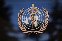 This picture taken on April 15, 2020 shows a sign of the World Health Organization (WHO) at the entrance of their headquarters in Geneva amid the COVID-19 outbreak, caused by the novel coronavirus. - Global efforts to join forces against the coronavirus faltered after Donald Trump froze funding for the World Health Organization, igniting a chorus of criticism from world leaders who urged solidarity in the face of a crippling economic crisis. (Photo by Fabrice COFFRINI / AFP)