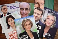 This picture taken on April 6, 2022 in Marseille, southern France, shows electoral leaflets of (from L to R) French leftist party La France Insoumise (LFI) presidential candidate Jean-Luc Melenchon, French Socialist Party (PS) presidential candidate Anne Hidalgo, French far-right party Reconquete! presidential candidate Eric Zemmour, French right-wing Les Republicains (LR) Ile-de-France Regional Council President and presidential candidate Valerie Pecresse Valerie Pecresse, France's President Emmanuel Macron, French ecologist party Europe Ecologie� Les Verts (EELV) presidential candidate Yannick Jadot and French far-right party Rassemblement National (RN) presidential candidate Marine Le Pen ahead of the first round of the French presidential election. (Photo by Nicolas TUCAT / AFP)