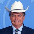 (FILES) In this file photo taken on January 29, 2020, Brazil's President Jair Bolsonaro gestures wearing a hat during a ceremony with singers of country music at Planalto Palace in Brasilia. - The outgoing Brazilian president Jair Bolsonaro, beaten in all the polls by his sworn enemy Lula, says he is sure of his victory in the first round of the October 2, 2022 election after four years of a mandate marked by crises. (Photo by Sergio LIMA / AFP)