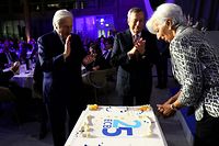 ECB President Christine Lagarde (R) and her predecessors, former ECB presidents Mario Draghi and Jean-Claude Trichet (L), cut a cake during celebrations of the European Central Bank ECB to mark its 25th anniversary at the ECB headquarters in Frankfurt am Main, western Germany on May 24, 2023. (Photo by KAI PFAFFENBACH / POOL / AFP)