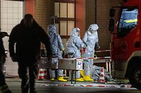 Agents wearing protective suits examine substances on the premises of the fire brigade in Castrop-Rauxel, western Germany on January 8, 2023 following arrests on suspicion of preparing an 'Islamist attack' using cyanide and ricin. - Munster police and the Dusseldorf prosecutors' office said in a press release that officers searched a residence in the town of Castrop-Rauxel for 'toxic substances' intended to carry out an attack. (Photo by Christoph Reichwein / DPA / AFP) / Germany OUT