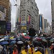 People gather for a rainy protest march in the Causeway Bay shopping district of Hong Kong on October 6, 2019. - A Hong Kong judge on October 6 rejected a challenge to an emergency law criminalising protesters wearing face masks as democracy activists hit the streets again in defiance of the ban despite half the city's subway stations remaining closed. (Photo by Nicolas ASFOURI / AFP)