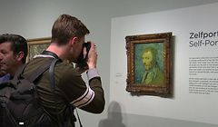 This video grab image shows a photographer taking a close up of a self-portrait by Dutch artist Vincent van Gogh on display at The Van Gogh Museum in Amsterdam on January 20, 2020, after it was declared as genuine. - A gloomy self-portrait by Vincent van Gogh was declared genuine after decades of uncertainty, experts identifying it as the only work painted by the Dutch master while he suffered from psychosis. The "Self Portrait (1889)" -- which shows the artist giving a haunted sideways glance against a swirling blue and yellow background -- was confirmed as authentic by the Van Gogh Museum in Amsterdam. (Photo by Sara MAGNIETTE / various sources / AFP)