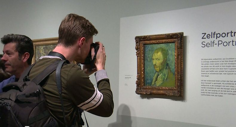 This video grab image shows a photographer taking a close up of a self-portrait by Dutch artist Vincent van Gogh on display at The Van Gogh Museum in Amsterdam on January 20, 2020, after it was declared as genuine. - A gloomy self-portrait by Vincent van Gogh was declared genuine after decades of uncertainty, experts identifying it as the only work painted by the Dutch master while he suffered from psychosis. The "Self Portrait (1889)" -- which shows the artist giving a haunted sideways glance against a swirling blue and yellow background -- was confirmed as authentic by the Van Gogh Museum in Amsterdam. (Photo by Sara MAGNIETTE / various sources / AFP)