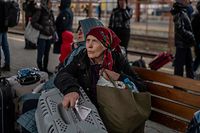 A Ukrainian evacuee waits to board a train en route to Warsaw at the rail station in Przemysl, near the Polish-Ukrainian border, on March 26, 2022, following Russia's military invasion launched on Ukraine. - Some 3.7 million people have fled Ukraine since Russia's invasion a month ago, the UN said on March 25. (Photo by Angelos Tzortzinis / AFP)