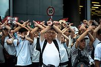 (FILES) In this file picture taken on June 9, 2019, protesters gesture as they chant "no extradition" as they rally against a controversial extradition law proposal in Hong Kong. - Hong Kong on June 9, 2020 marks a year since pro-democracy protests erupted, but a resumption of city-wide unrest is unlikely as activists reel from mass arrests, coronavirus bans on public gatherings and a looming national security law. (Photo by PHILIP FONG / AFP)
