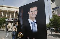 A picture taken on May 3, 2021 shows a giant portrait of President Bashar al-Assad at the Sabaa Bahrat square in Syria's capital Damascus ahead of this month's presidential elections. - A Syrian former minister and a member of the Damascus-tolerated opposition will face Bashar al-Assad in this month's presidential election, the constitutional court said Monday. The Assad-appointed body approved only three out of 51 applications to stand in the May 26 ballot, among them the 55-year-old president himself, (Photo by LOUAI BESHARA / AFP)