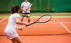 Tennis players playing a match on the court on a sunny day