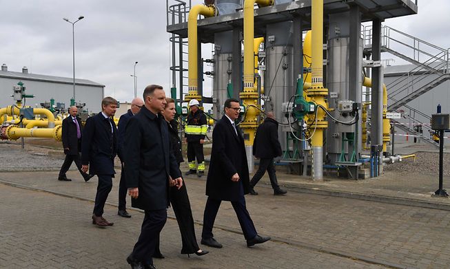 Poland's President Andrzej Duda (left) Denmark's Prime Minister Mette Frederiksen (centre) and Polish Prime Minister Mateusz Morawiecki (right) walk over the grounds of the Baltic Pipe gas pipeline on 27 September. 
