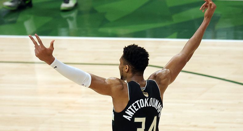 MILWAUKEE, WISCONSIN - JULY 20: Giannis Antetokounmpo #34 of the Milwaukee Bucks celebrates in the final seconds before defeating the Phoenix Suns in Game Six to win the 2021 NBA Finals at Fiserv Forum on July 20, 2021 in Milwaukee, Wisconsin. NOTE TO USER: User expressly acknowledges and agrees that, by downloading and or using this photograph, User is consenting to the terms and conditions of the Getty Images License Agreement.   Jonathan Daniel/Getty Images/AFP
== FOR NEWSPAPERS, INTERNET, TELCOS & TELEVISION USE ONLY ==