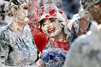 A foam covered student from St Andrews University participates in the traditional Raisin Monday celebrations in St Andrews, Scotland October 29, 2012. The tradition dates back to the early days of the university when new students would give senior students one pound (0.45kg) of raisins in gratitude for their help in adapting to university life, in exchange for a receipt written in Latin. Failure to produce such a receipt could result in a dousing in the local fountain. Nowadays the raisins have been replaced with a bottle of wine and the dousing with foam. REUTERS/David Moir (BRITAIN - Tags: EDUCATION SOCIETY)