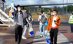 This handout picture taken on November 30, 2020 and released by Charles Darwin University shows foreign students disembarking from an international flight at Darwin Airport in Darwin. - International students have arrived in Australia for the first time since the country shut its borders to curb coronavirus in March, with a charter flight touching down in Darwin on November 30. (Photo by JULES / Charles Darwin University / AFP) / ----EDITORS NOTE ----RESTRICTED TO EDITORIAL USE MANDATORY CREDIT " AFP PHOTO / CHARLES DARWIN UNIVERSITY / JULES - NO MARKETING NO ADVERTISING CAMPAIGNS - DISTRIBUTED AS A SERVICE TO CLIENTS-NO ARCHIVE