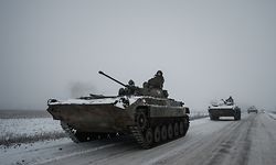TOPSHOT - Ukrainian BMP-2 infantry combat vehicles drive in a convoy down an icy road in the Donetsk region on January 30, 2023, amid the Russian invasion of Ukraine. (Photo by YASUYOSHI CHIBA / AFP)