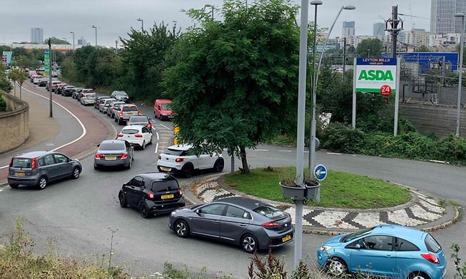 Customers queue to access an Asda petrol station in east London on Saturday