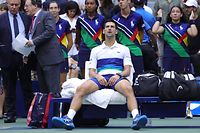 (FILES) In this file photograph taken on September 13, 2021, Serbia's Novak Djokovic sits in his courtside chair after losing to Russia's Daniil Medvedev during their 2021 US Open Tennis tournament men's final match at the USTA Billie Jean King National Tennis Center in New York. - Novak Djokovic announced on August 25, 2022, shortly before the draw, that he would not be able to take part in the US Open, which starts on August 29, because he cannot travel to the United States because he has not been vaccinated against Covid-19. (Photo by Kena Betancur / AFP)