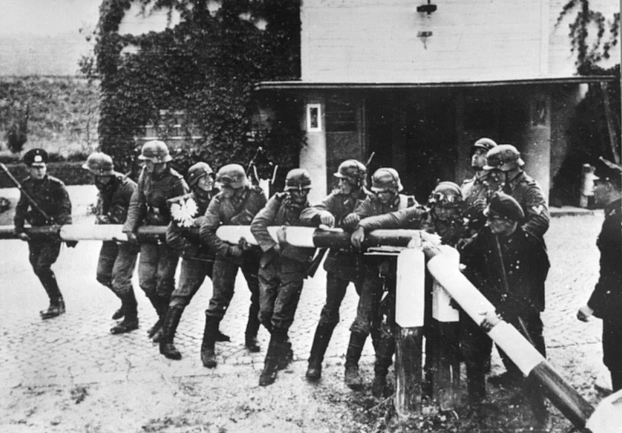 Beim Einmarsch deutscher Truppen in Polen am 1. September 1939 reißen Soldaten der deutschen Wehrmacht einen Schlagbaum an der deutsch-polnischen Grenze nieder.