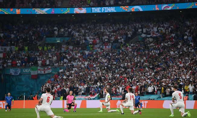 Players take a knee ahead of the UEFA EURO 2020 final football match between Italy and England at Wembley Stadium in London