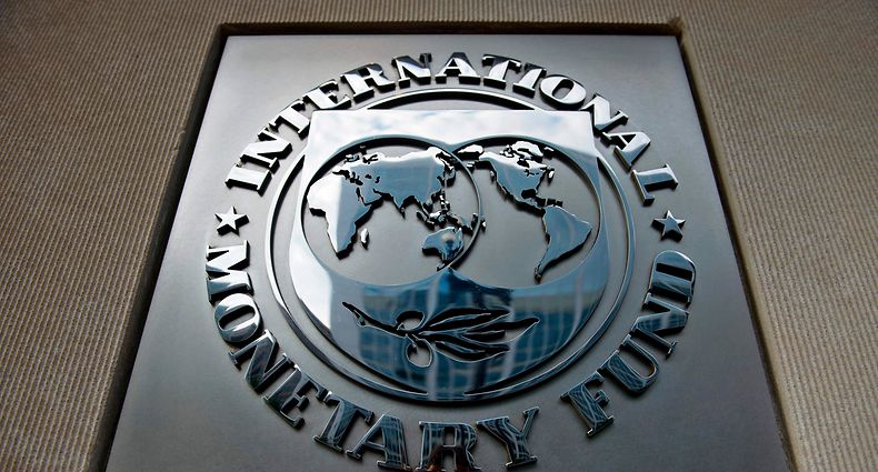 (FILES) In this file photo taken on June 30, 2015 a logo is seen outside the headquarters of the International Monetary Fund  in Washington, DC. - Improving US-China trade tensions have eased uncertainty and the world economy may have hit bottom but a sharp slowdown in India is creating a drag worldwide, the International Monetary Fund said on January 20, 2020. However, while the risks to the global economy have lessened, the Washington-based global lending institution cautioned that outcomes "depend to an important extent on avoiding further escalation" between Washington and Beijing. (Photo by Brendan SMIALOWSKI / AFP)