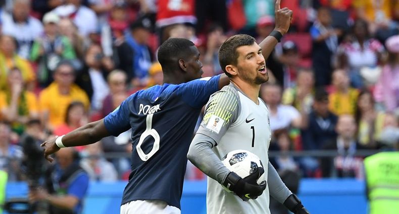 France's midfielder Paul Pogba (back) celebrates as Australia's goalkeeper Mathew Ryan reacts to conceding a goal during the Russia 2018 World Cup Group C football match between France and Australia at the Kazan Arena in Kazan on June 16, 2018. / AFP PHOTO / Kirill KUDRYAVTSEV / RESTRICTED TO EDITORIAL USE - NO MOBILE PUSH ALERTS/DOWNLOADS