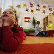 Children play with their nursery school teacher at their Kindergarten in Hanau, 30km (18 miles) south of Frankfurt, March 12, 2013. Despite a drive in German Chancellor Angela Merkel's first term to boost the number of childcare spots, Germany's birthrate remains one of the lowest in Europe.  REUTERS/Kai Pfaffenbach (GERMANY - Tags: POLITICS EDUCATION SOCIETY)