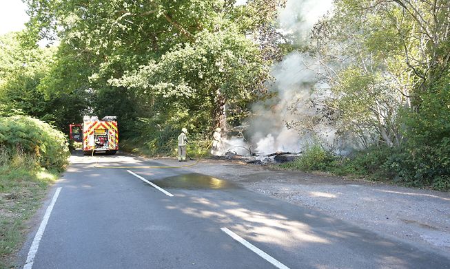 Firemen putting out a wildfire by the side of the road in Ardingly, West Sussex during the drought condition's of the summer on the 07th August 2022