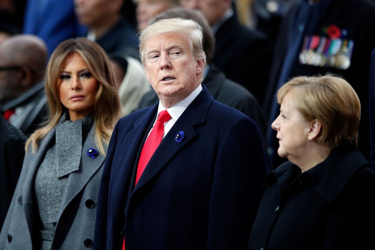President Donald Trump (C), his wife Melania Trump (L) and German Chancellor Angela Merkel (R) look on as they attend a ceremony at the Arc de Triomphe in Paris on November 11, 2018 as part of commemorations marking the 100th anniversary of the 11 November 1918 armistice, ending World War I. (Photo by Francois Mori / various sources / AFP)