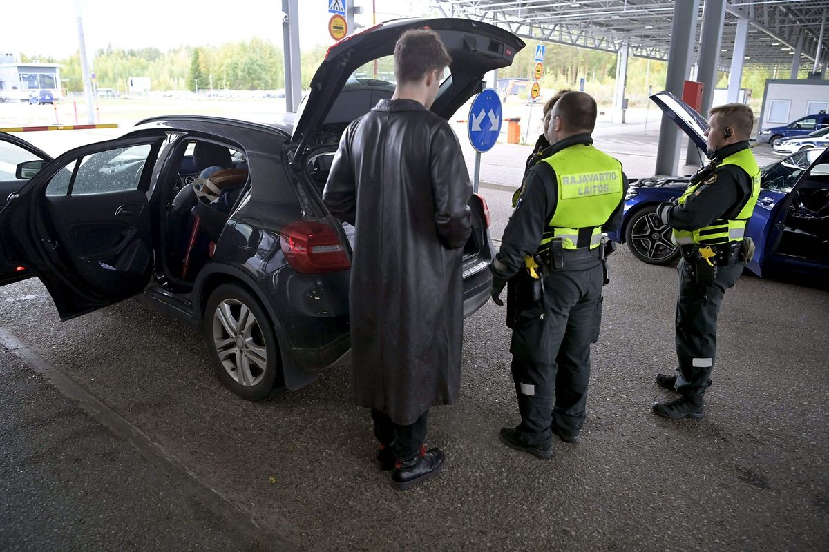 Ivan, 23, of Russia waits as Finnish border guards check his family's car at the border check point in Virolahti, Finland, on Sunday