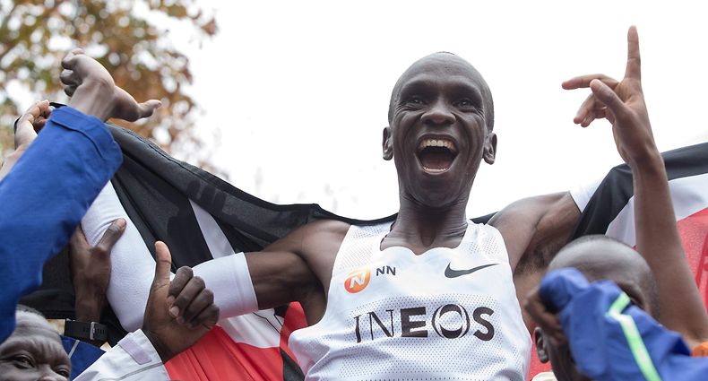 Kenya's Eliud Kipchoge (white jersey) celebrates after crossing the finish line at the end of his attempt to bust the mythical two-hour barrier for the marathon on October 12 2019 in Vienna. - Kipchoge holds the men's world record for the distance with a time of 2hr 01min 39sec, which he set in the flat Berlin marathon on September 16, 2018.
He tried in May 2017 to break the two-hour barrier, running on the Monza National Autodrome racing circuit in Italy, failing narrowly in 2hr 00min 25sec. (Photo by ALEX HALADA / AFP)