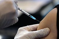 An Israeli health worker injects a dose of the Pfizer-BioNtech Covid-19 vaccine, at the Clalit Health Services installed at the Pais Arena Sport Hall in Jerusalem, on January 21, 2021. (Photo by Emmanuel DUNAND / AFP)
