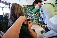 A child receives a dose of a vaccine against coronavirus Covid-19 at the Antwerp Zoo, on January 8, 2022. (Photo by JONAS ROOSENS / various sources / AFP) / Belgium OUT