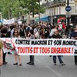 People hold a banner reading "Against Macron and his world, everyone together" as they take part in a "maree populaire" (working-class tide) demonstration called by political organisations, associations and unions to protest against French President and government's policy, in Paris on May 26, 2018. / AFP PHOTO / JACQUES DEMARTHON