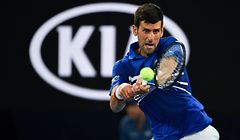 Serbia's Novak Djokovic hits a return against France's Lucas Pouille during their men's singles semi-final match on day 12 of the Australian Open tennis tournament in Melbourne on January 25, 2019. (Photo by Paul Crock / AFP) / -- IMAGE RESTRICTED TO EDITORIAL USE - STRICTLY NO COMMERCIAL USE --