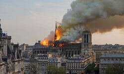 TOPSHOT - Smoke billows as flames burn through the roof of the Notre-Dame de Paris Cathedral on April 15, 2019, in the French capital Paris. - A huge fire swept through the roof of the famed Notre-Dame Cathedral in central Paris on April 15, 2019, sending flames and huge clouds of grey smoke billowing into the sky. The flames and smoke plumed from the spire and roof of the gothic cathedral, visited by millions of people a year. A spokesman for the cathedral told AFP that the wooden structure supporting the roof was being gutted by the blaze. (Photo by Fabien Barrau / AFP)