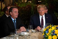 (FILES) In this file photo US President Donald Trump (R) speaks with Brazilian President Jair Bolsonaro during a dinner at Mar-a-Lago in Palm Beach, Florida, on March 7, 2020. - Brazilian President Jair Bolsonaro's press secretary tested positive for coronavirus days after taking part in meetings with President Trump at Mar-a-Lago, Brazilian newspaper O Estado de S. Paulo reported and multiple US outlets have confirmed on March 12, 2020. (Photo by JIM WATSON / AFP)
