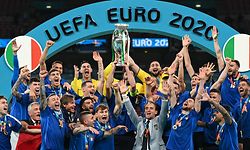 Italy's defender Giorgio Chiellini raises the European Championship trophy during the presentation after Italy won the UEFA EURO 2020 final football match between Italy and England at the Wembley Stadium in London on July 11, 2021. (Photo by Michael Regan / POOL / AFP)